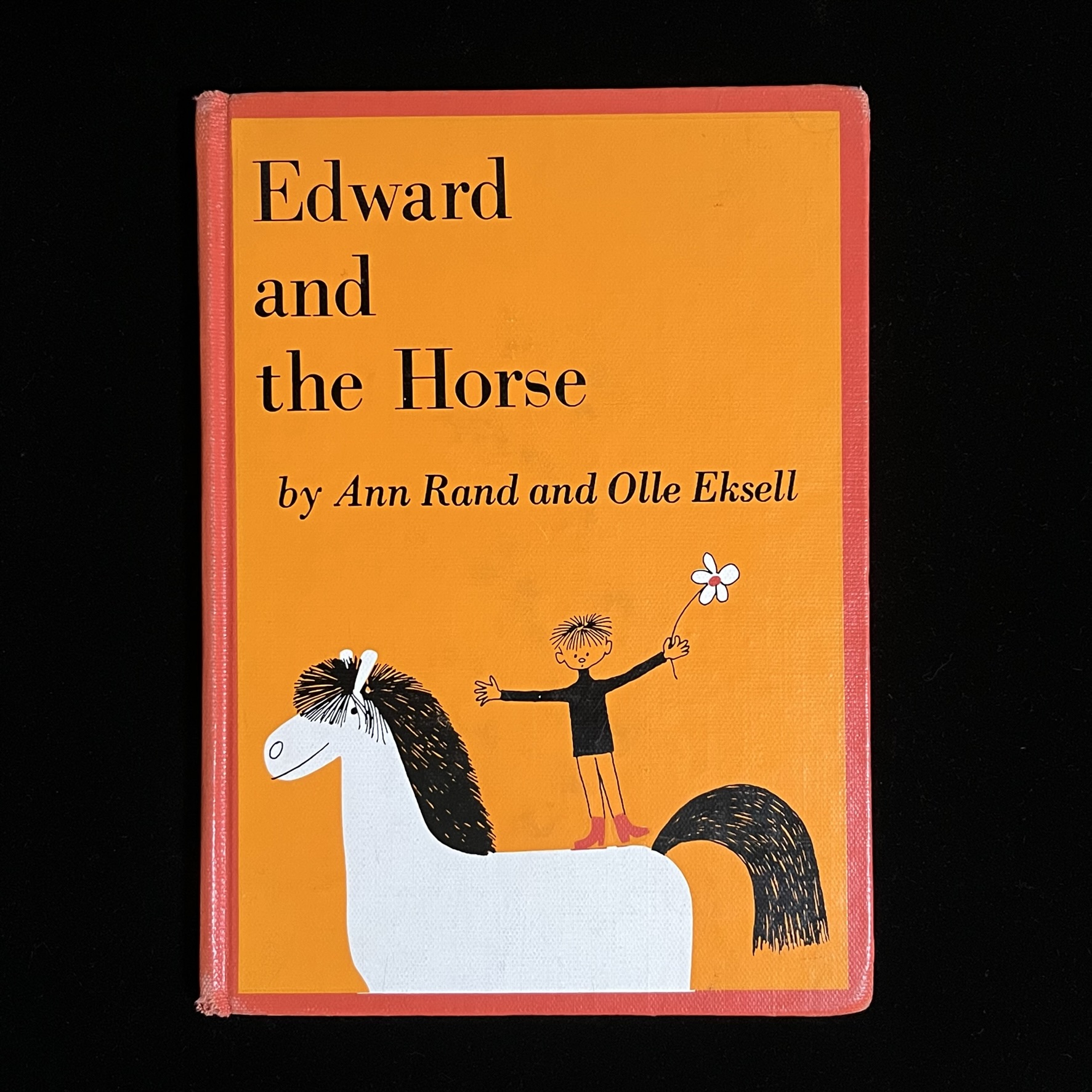 『Edward and the horse』の絵本の表紙の写真です。白い馬の上に白いお花を持ったエドワードくんが立ち乗りしているイラストがのっています。