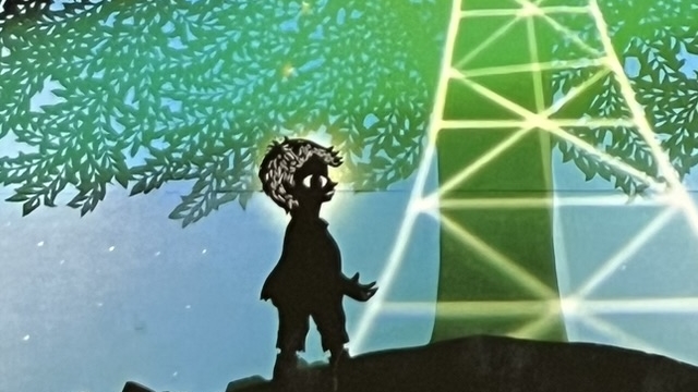 『銀河鉄道の夜』の絵本の表紙のイラストです。影絵の男の子が夜空のもと丘の上の木の下に立っていて、空には銀河鉄道が走っています。
