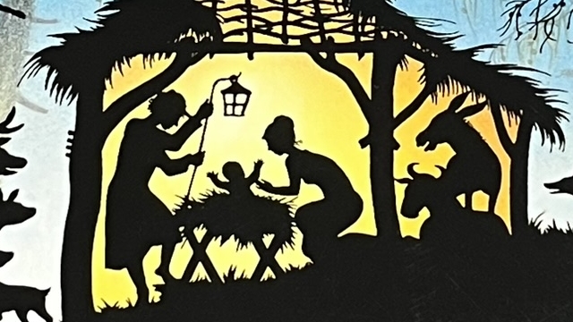 『クリスマス』の絵本の表紙のイラストです。納屋の中で赤ちゃんが誕生したシーンが影絵で描かれています。