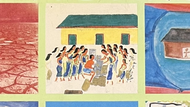 『人間の大地』の本の表紙です。みんなが集まっている絵や、乾いた大地の写真が載っています。