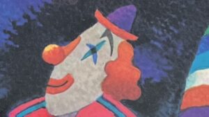 『アパートのまど』の絵本の表紙です。ピエロが描かれています。