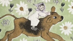 『黒い体の、白いひづめの牛』の絵本の表紙です。頭巾をかぶった女の子が茶色い牛に乗っている絵が描かれています。