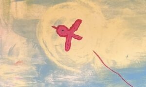 『とどけありがとう』の絵本の表紙です。空を飛んでいる赤い小鳥の絵が描かれています。